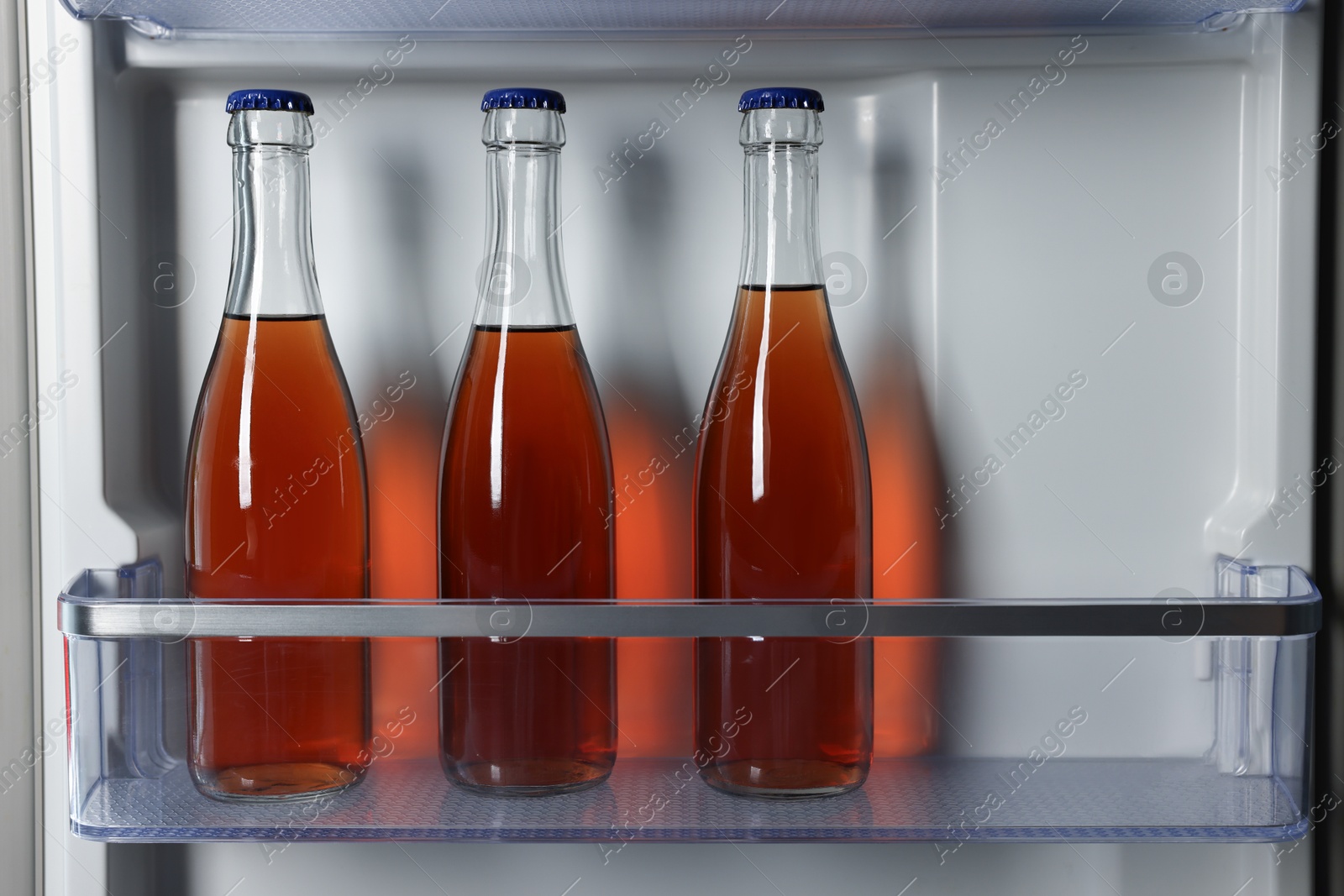 Photo of Many bottles of drinks in refrigerator, closeup