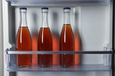 Photo of Many bottles of drinks in refrigerator, closeup