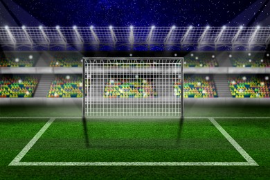 Image of Football stadium with illumination, goal and green grass