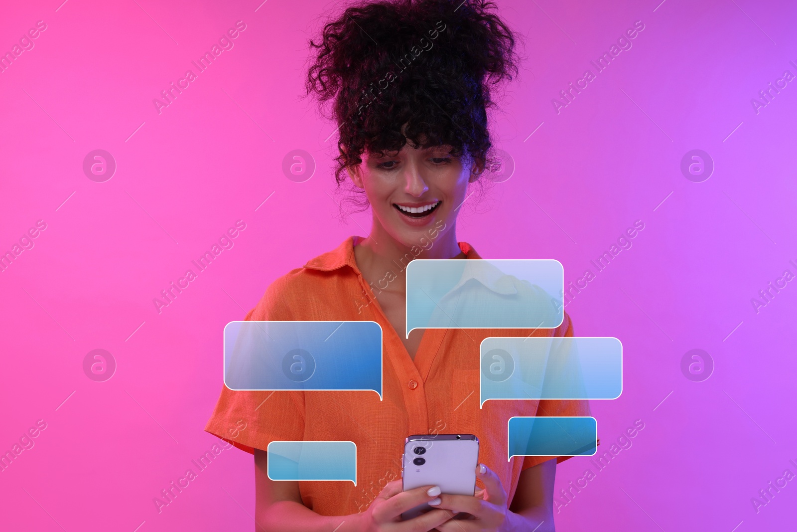 Image of Happy woman sending message via smartphone on pink gradient background. Speech bubbles near device