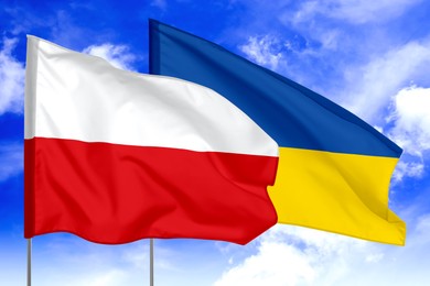 Image of Flags of Poland and Ukraine against sky. Diplomatic international relations