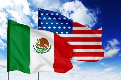 Image of Flags of Mexico and USA against sky. Diplomatic international relations