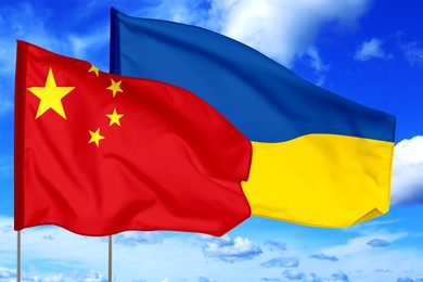 Image of Flags of China and Ukraine against sky. Diplomatic international relations