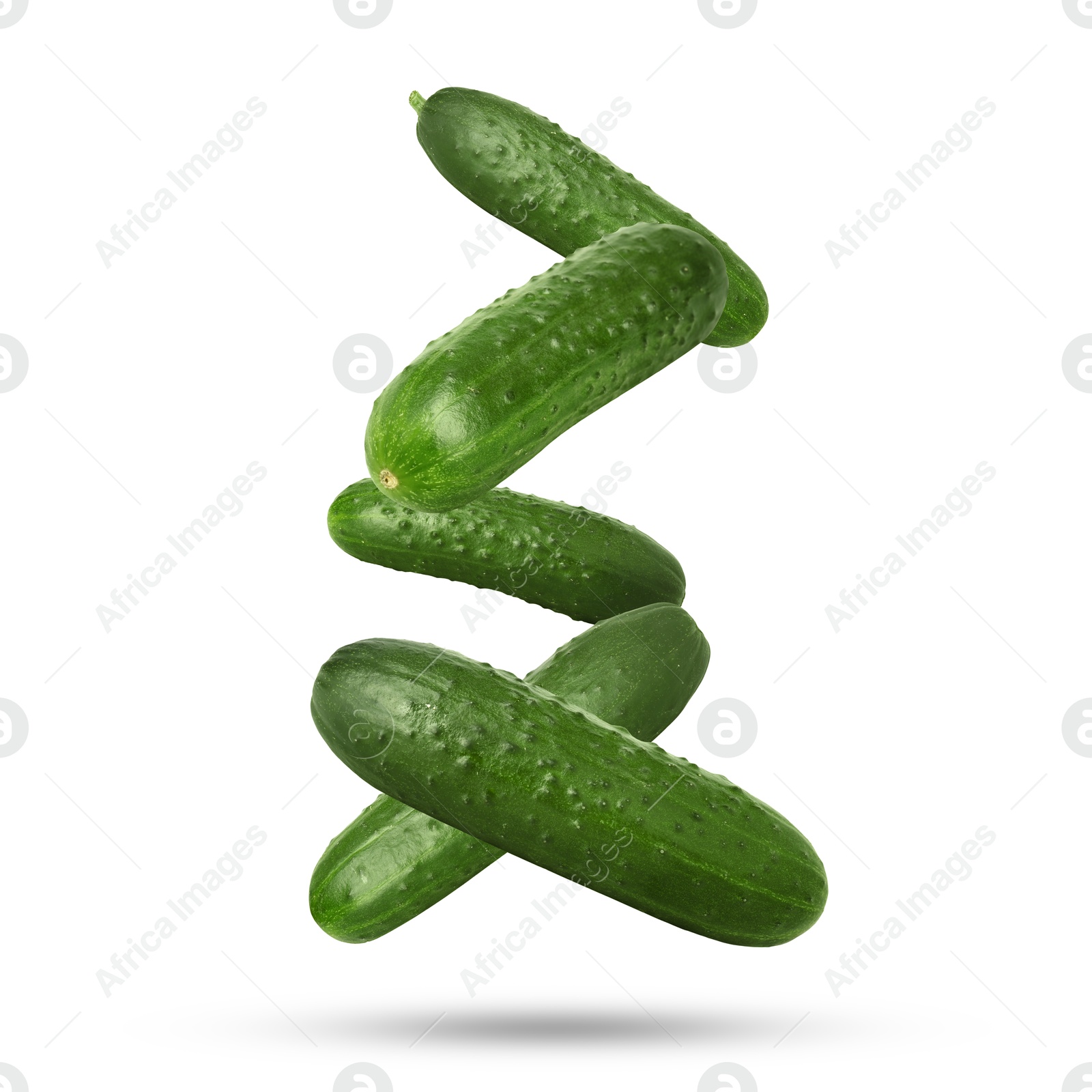 Image of Whole ripe cucumbers falling on white background