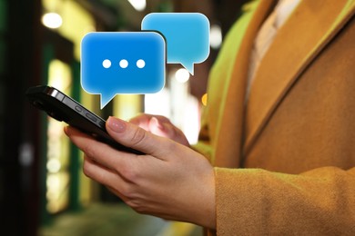 Image of Woman sending message via smartphone outdoors, closeup. Different speech bubbles near device