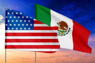 Image of Flags of USA and Mexico against sky. Diplomatic international relations