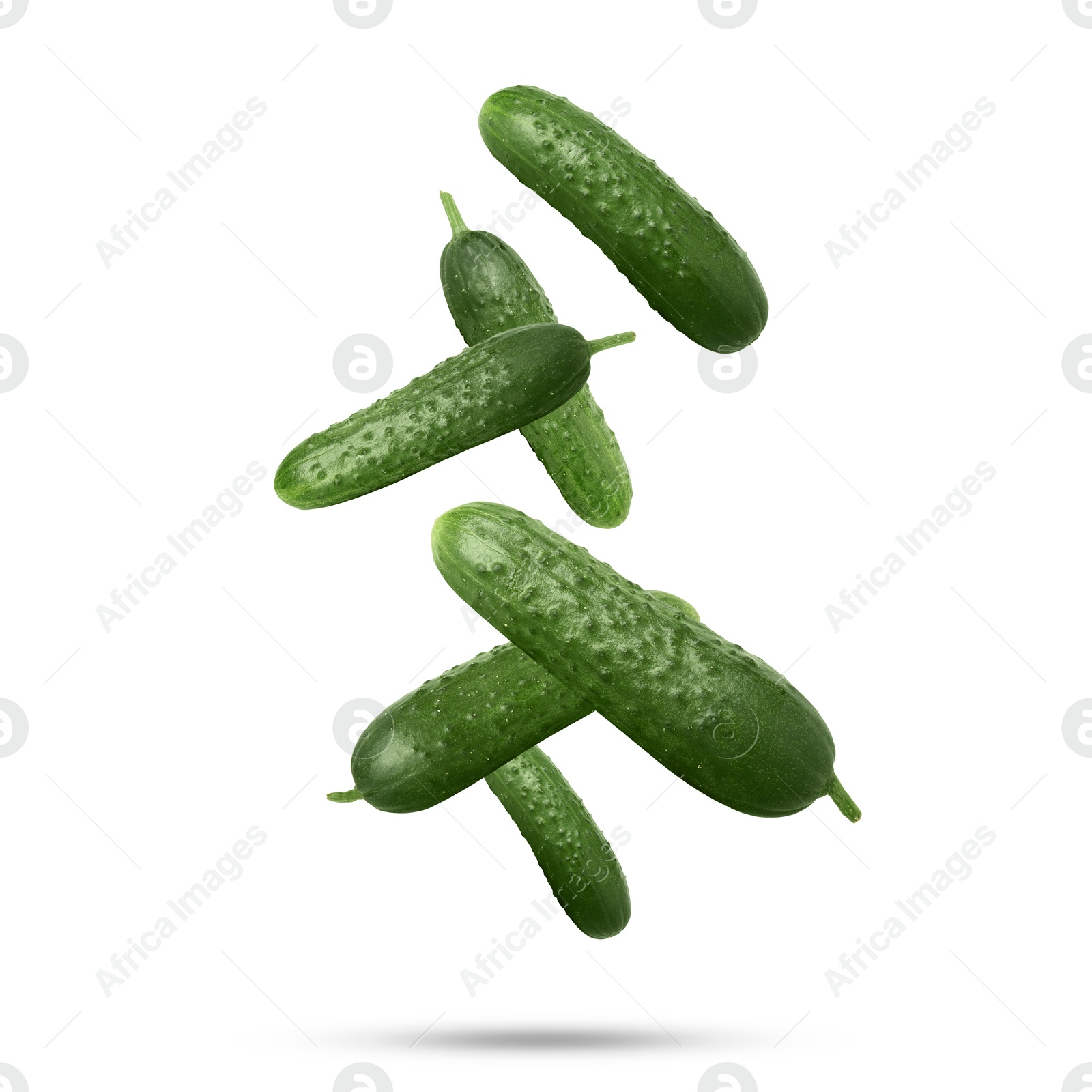 Image of Whole ripe cucumbers falling on white background