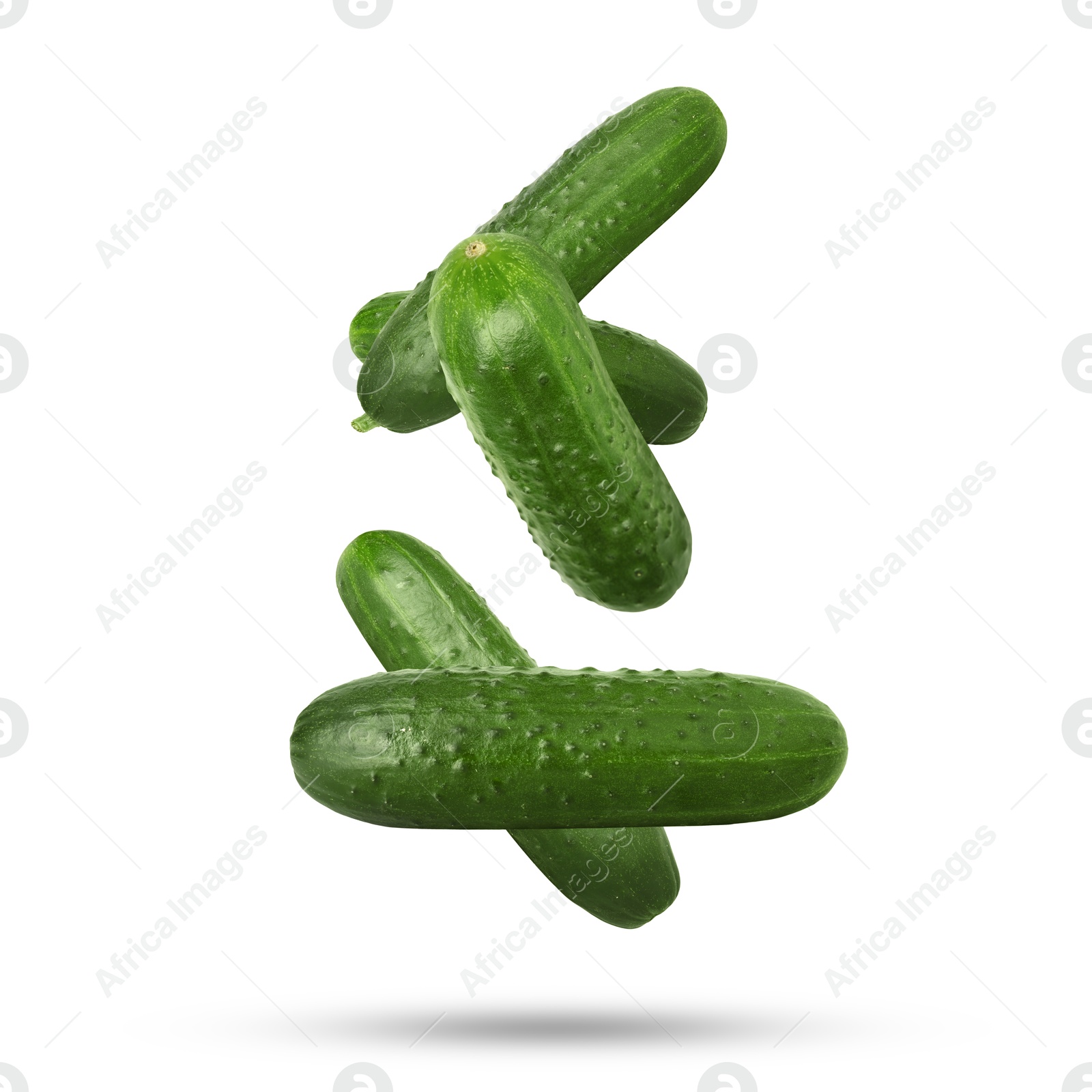 Image of Whole ripe cucumbers falling on white background