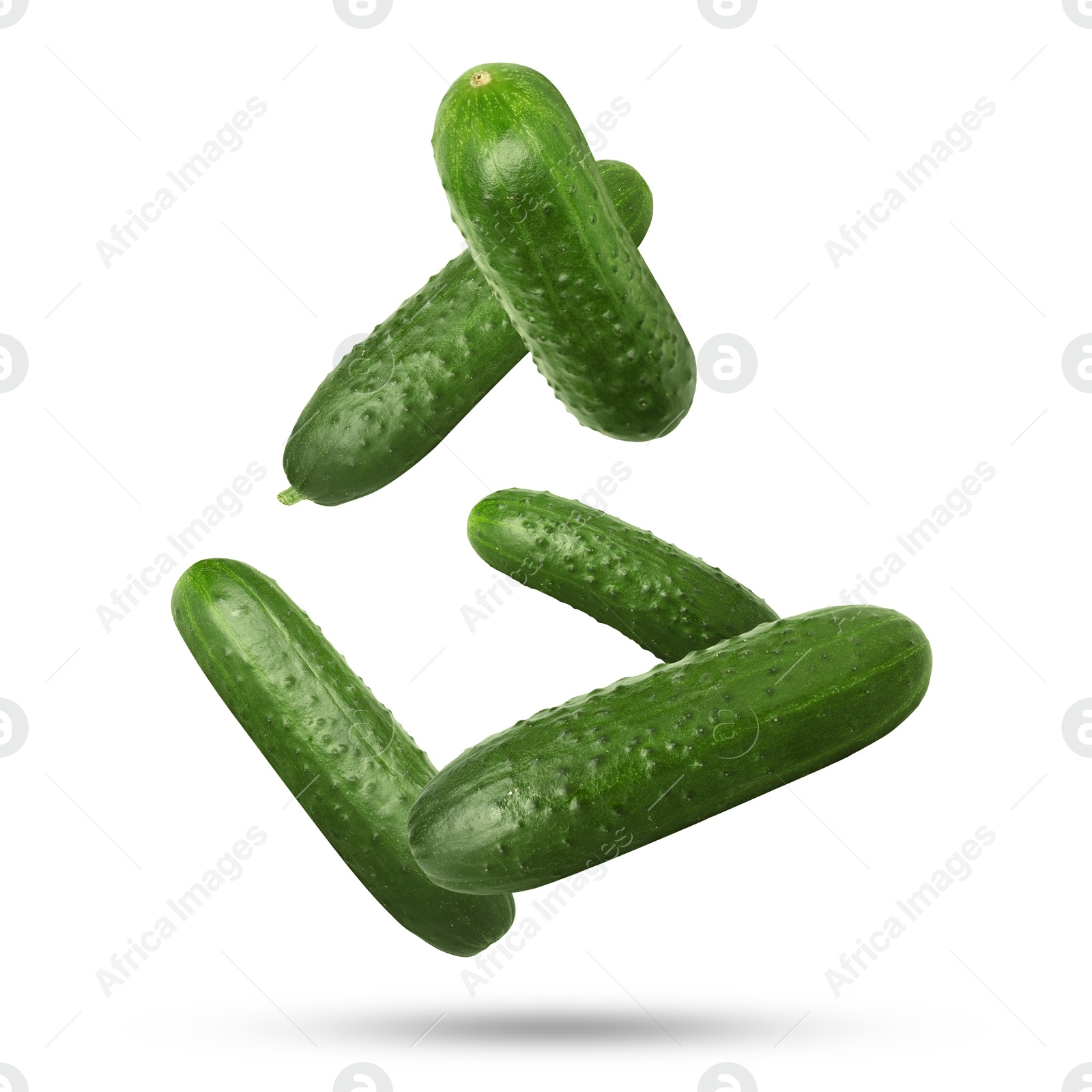 Image of Whole ripe cucumbers falling on white background