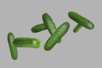 Image of Whole ripe cucumbers flying on grey background