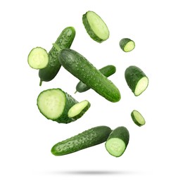 Image of Many ripe cucumbers falling on white background