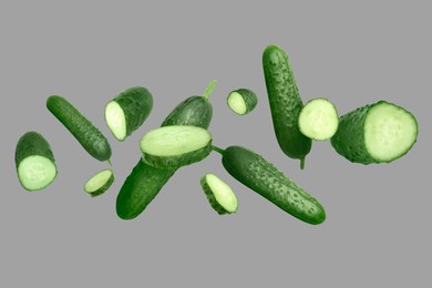 Image of Many ripe cucumbers flying on grey background