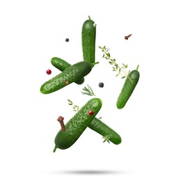 Image of Ripe cucumbers, herbs and spices falling on white background