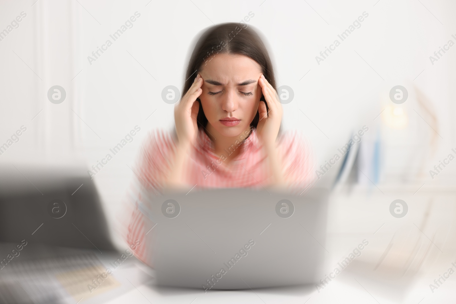 Image of Woman suffering from headache indoors, motion blur effect