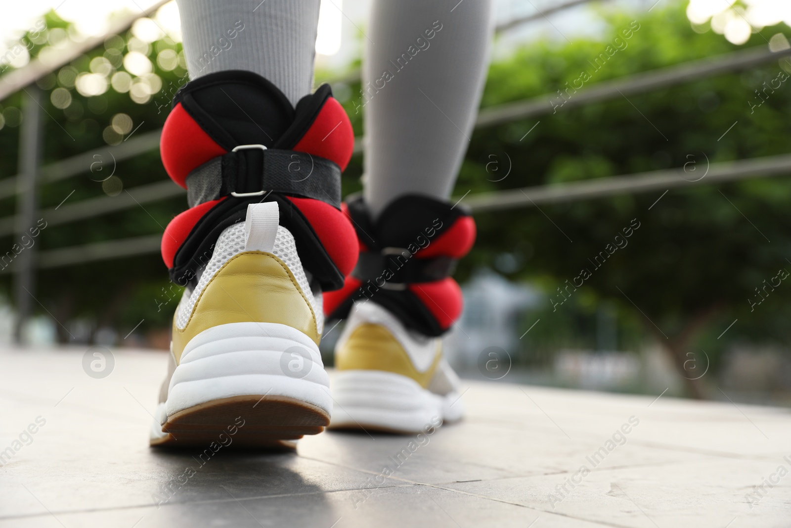 Photo of Woman with ankle weights walking outdoors, closeup