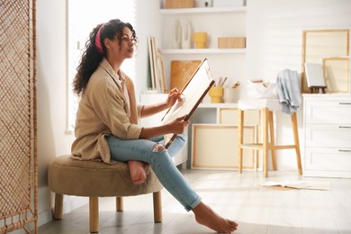 Photo of Beautiful woman drawing picture with pencil in studio