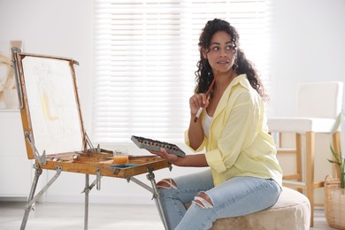 Photo of Beautiful woman drawing picture in art studio