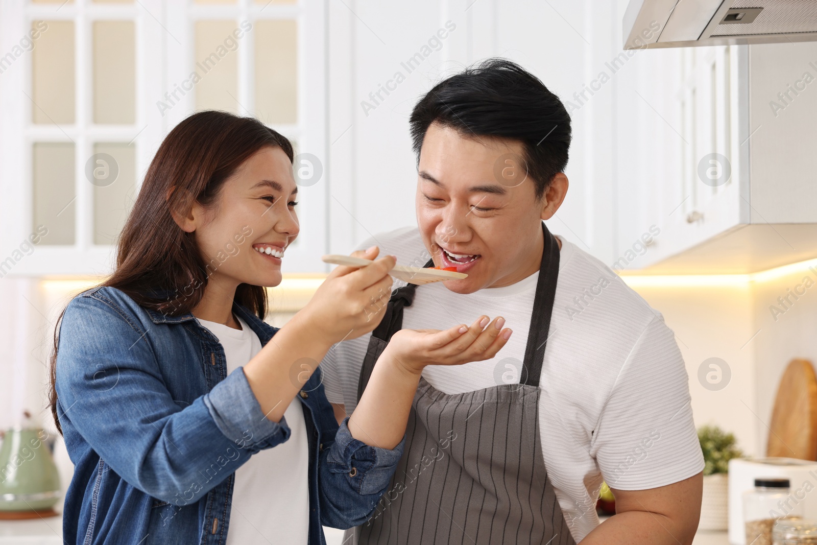 Photo of Happy lovely couple cooking together in kitchen