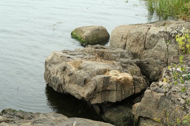 Photo of Different rocks near river on summer day