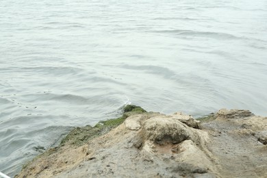 Photo of Rock and river water with waves on summer day