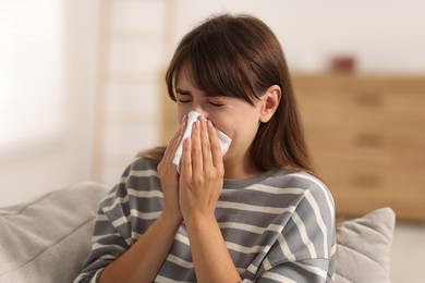 Photo of Woman with napkin suffering from sinusitis at home