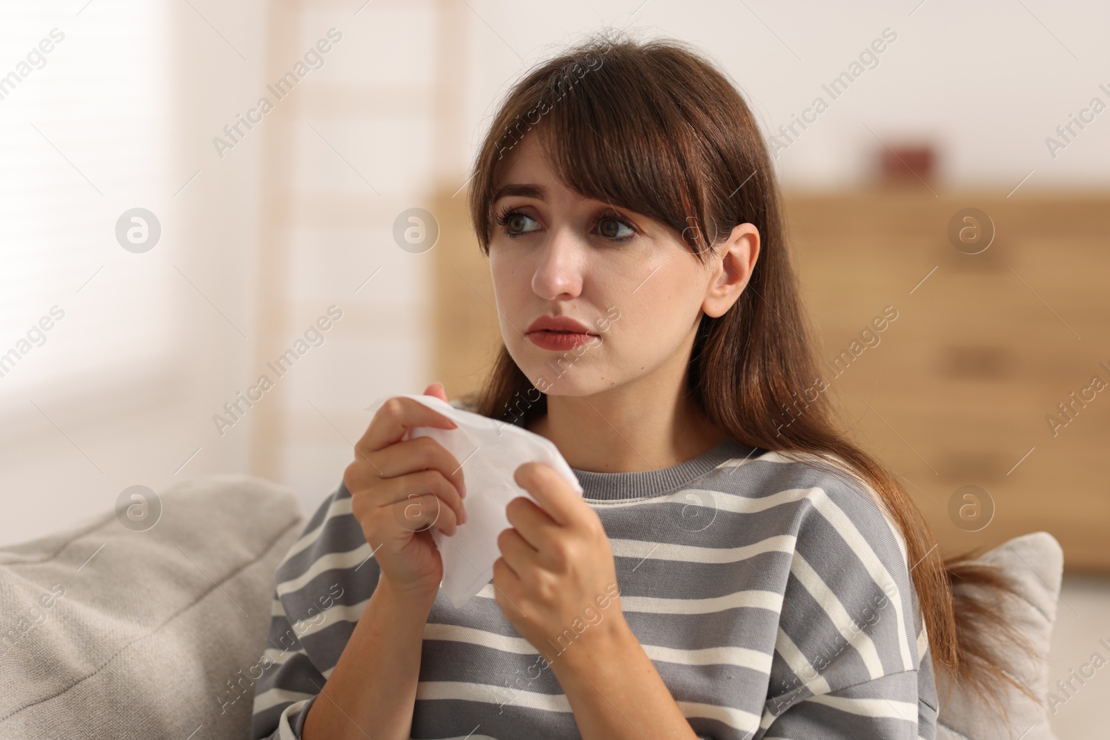 Photo of Woman with napkin suffering from sinusitis at home