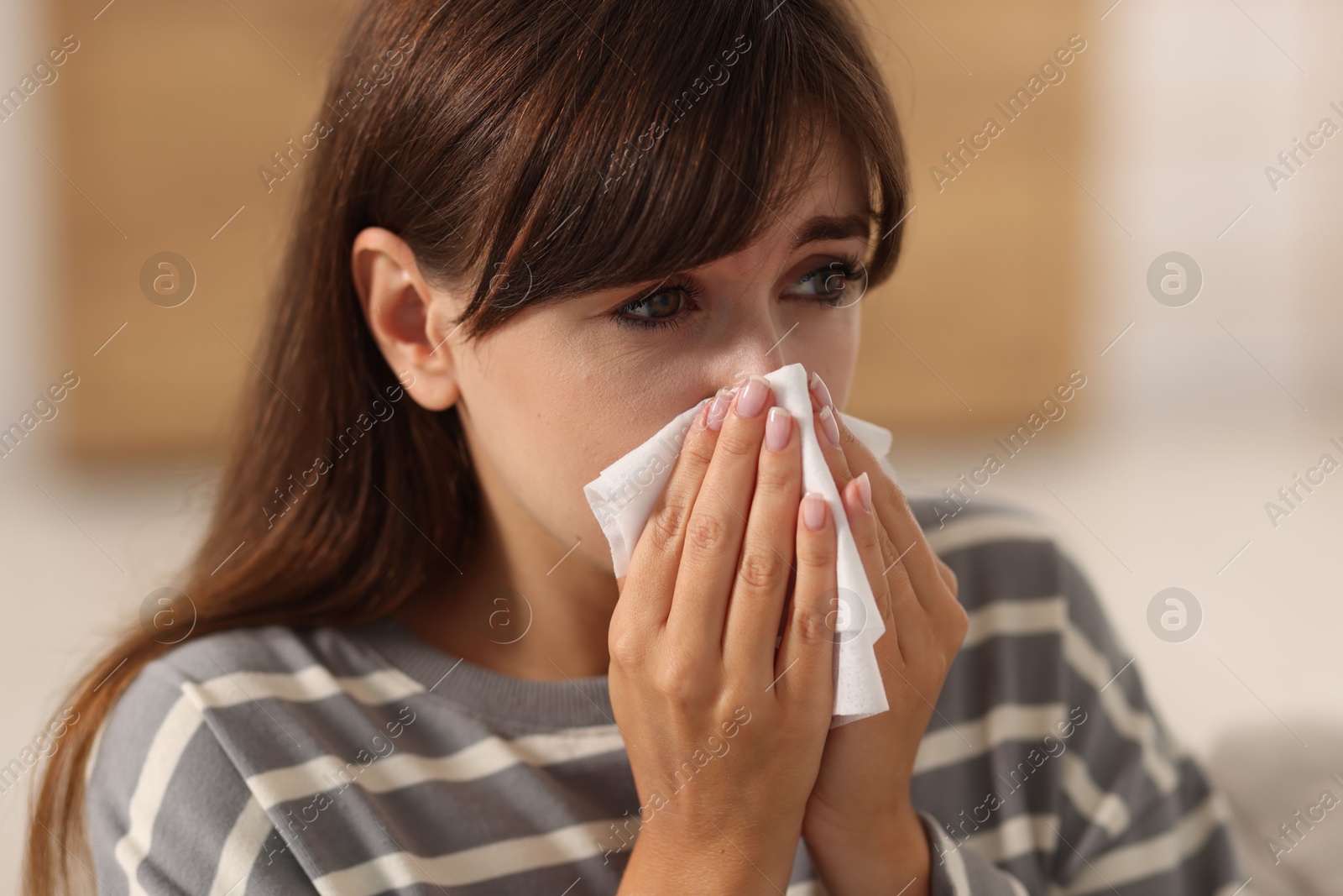 Photo of Woman with napkin suffering from sinusitis at home