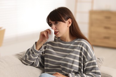 Photo of Woman with napkin suffering from sinusitis at home