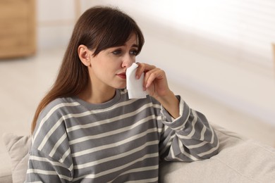 Photo of Woman with napkin suffering from sinusitis at home