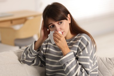 Photo of Woman with napkin suffering from sinusitis at home