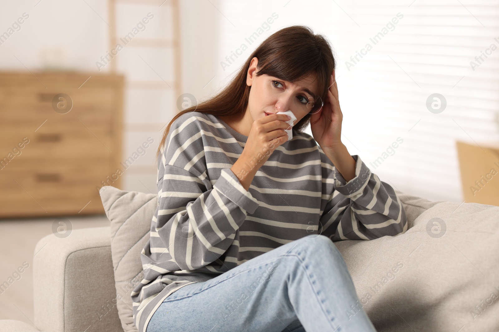 Photo of Woman with napkin suffering from sinusitis at home