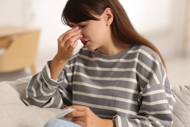 Photo of Woman with napkin suffering from sinusitis at home