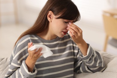 Photo of Woman with napkin suffering from sinusitis at home