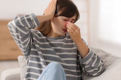 Photo of Tired woman suffering from sinusitis at home