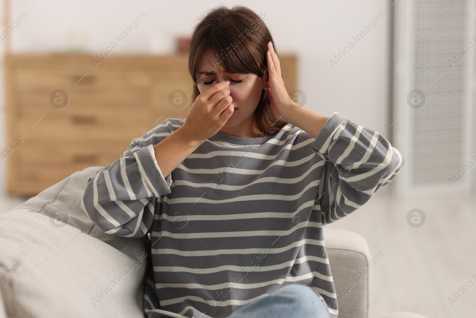 Photo of Tired woman suffering from sinusitis at home