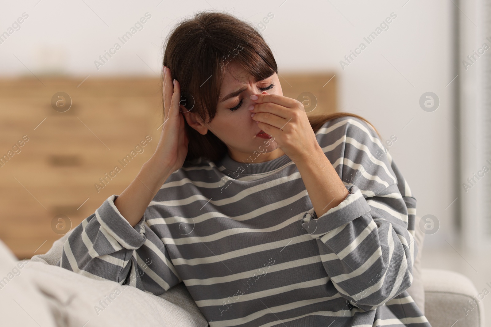 Photo of Tired woman suffering from sinusitis at home