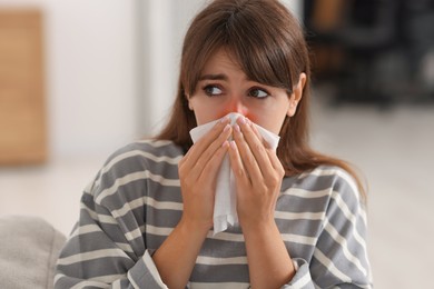 Woman with napkin suffering from sinusitis at home