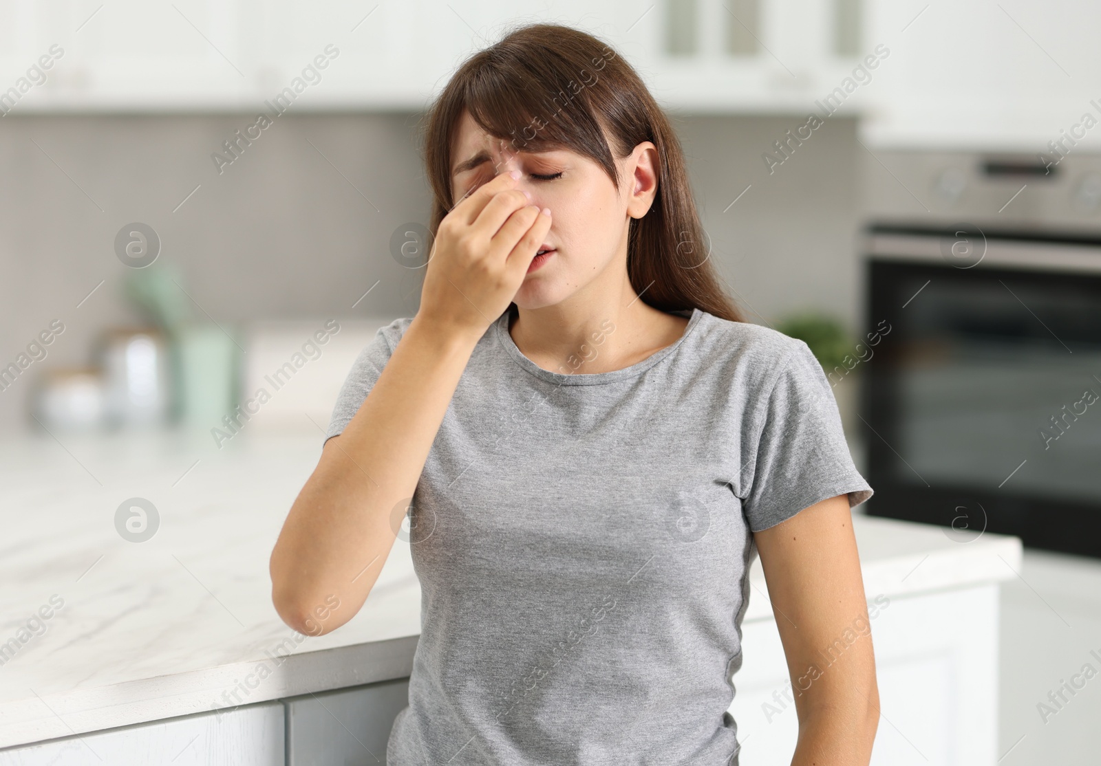 Photo of Tired woman suffering from sinusitis at home