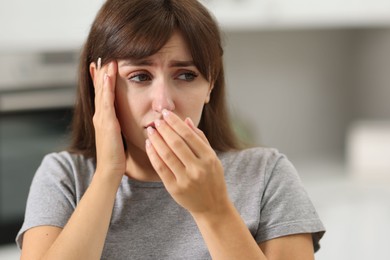 Photo of Tired woman suffering from sinusitis at home