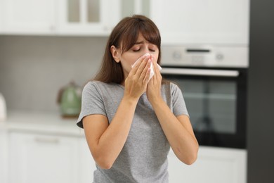 Photo of Woman with napkin suffering from sinusitis at home