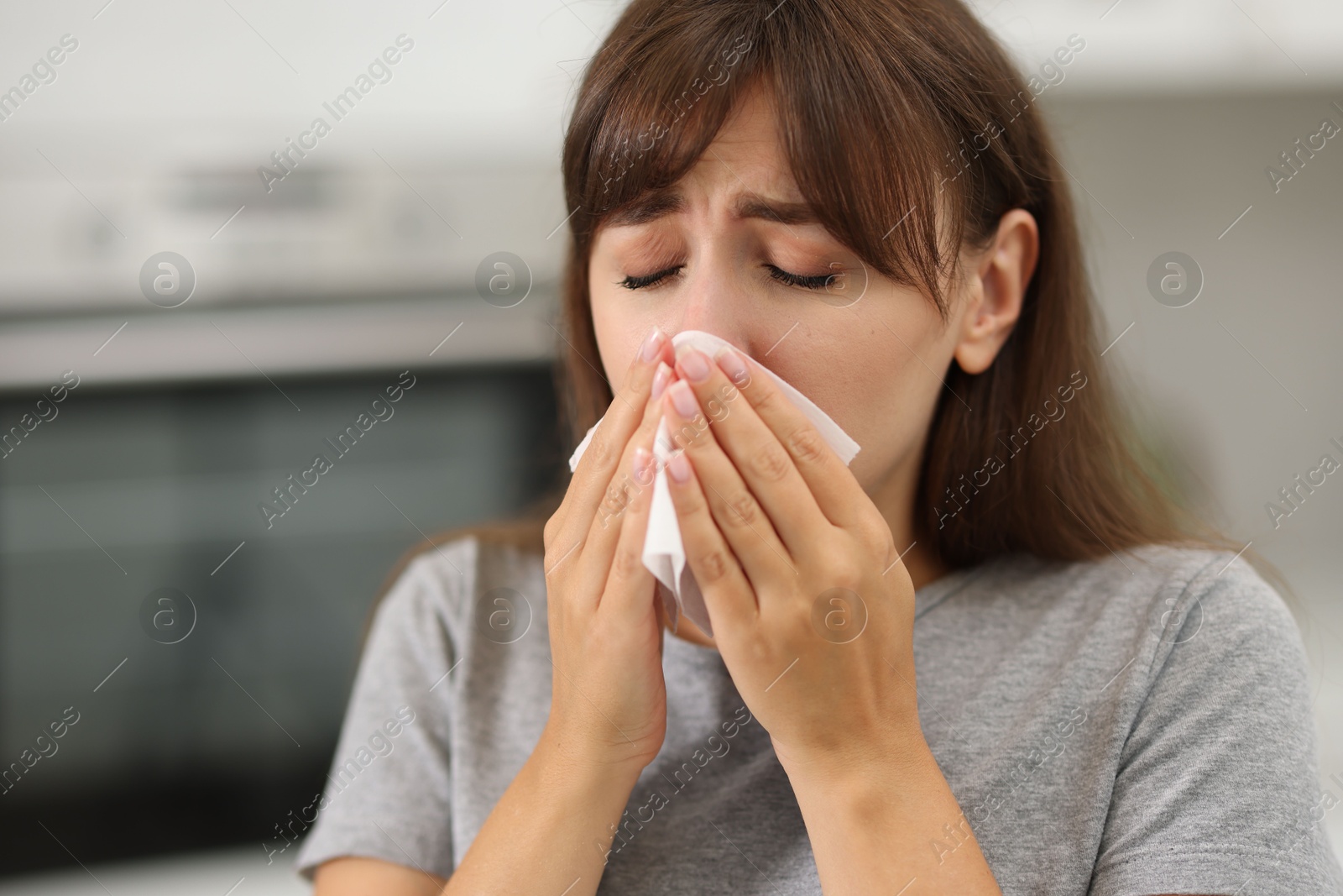 Photo of Woman with napkin suffering from sinusitis at home