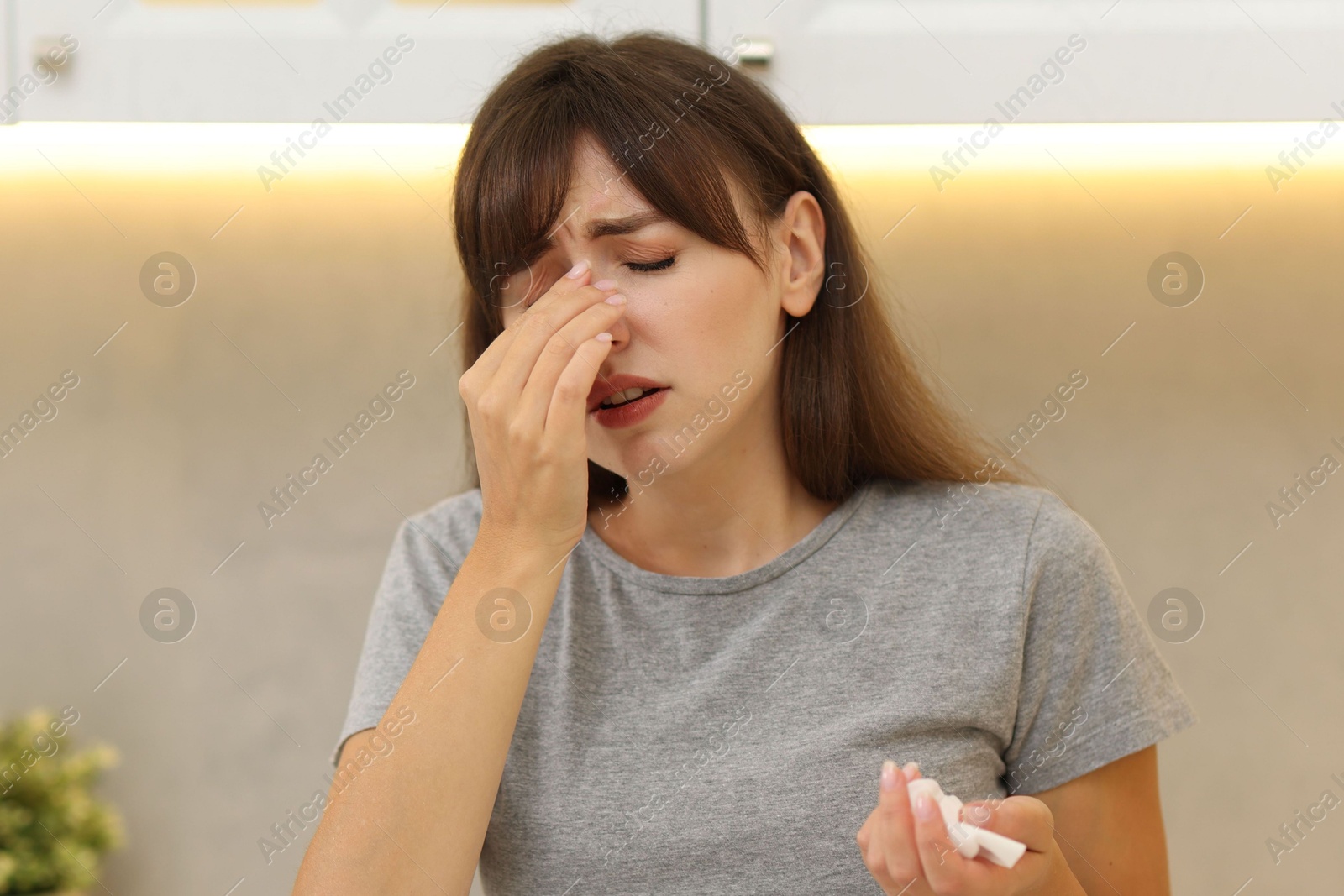 Photo of Tired woman suffering from sinusitis at home