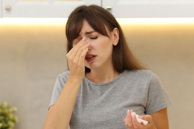 Photo of Tired woman suffering from sinusitis at home