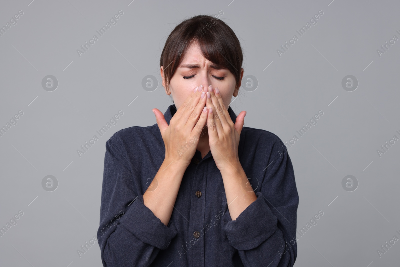 Photo of Woman suffering from sinusitis on grey background