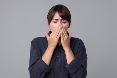 Photo of Woman suffering from sinusitis on grey background