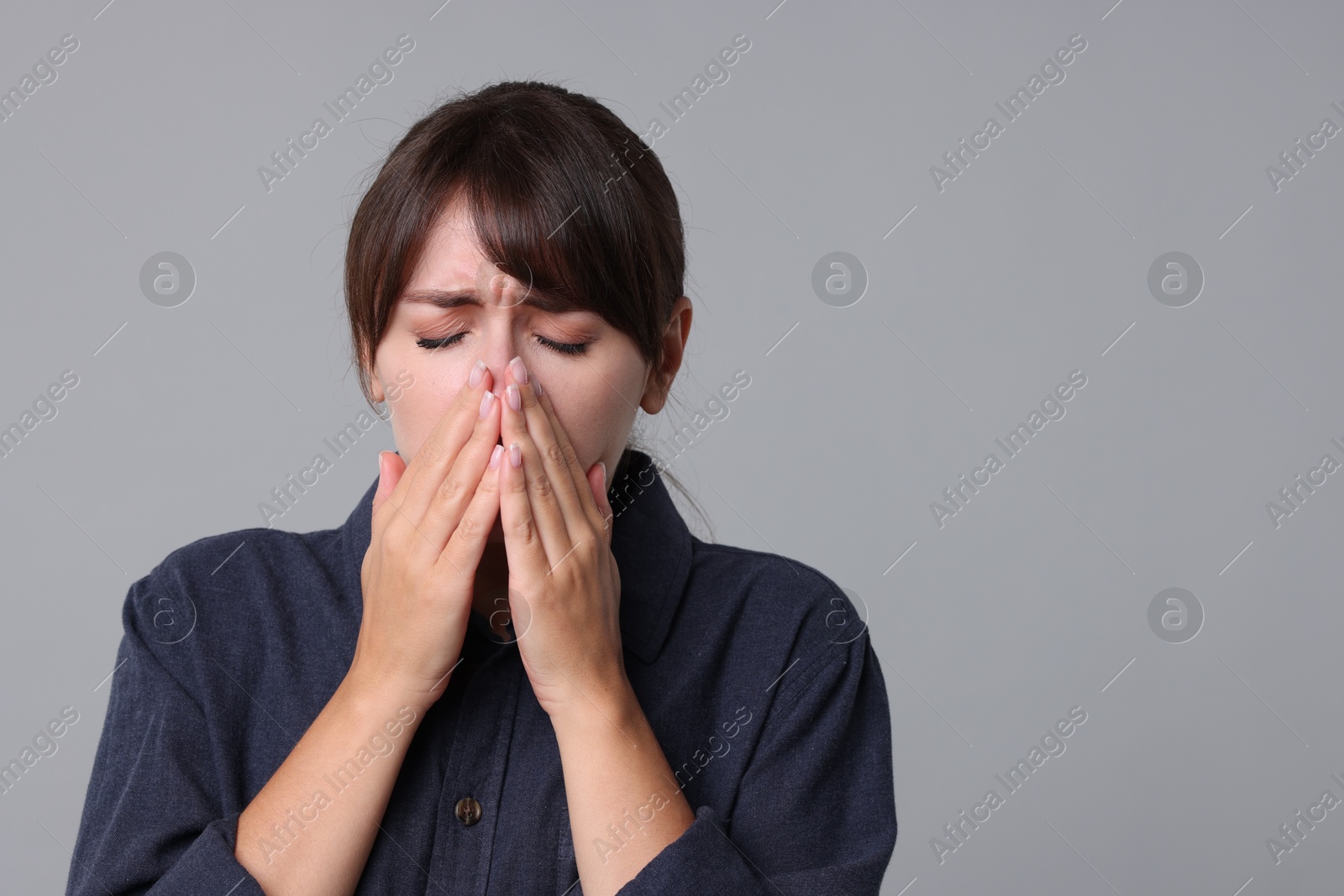 Photo of Woman suffering from sinusitis on grey background. Space for text