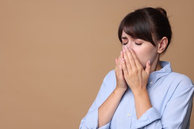 Photo of Woman suffering from sinusitis on beige background. Space for text