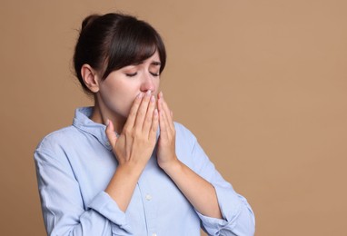 Photo of Woman suffering from sinusitis on beige background. Space for text