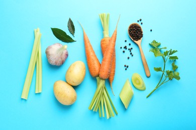 Photo of Fresh ripe carrots, vegetables, spices and spoon on light blue background, flat lay