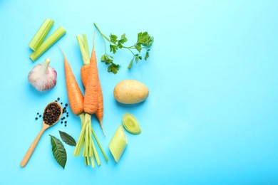 Photo of Fresh ripe carrots, vegetables, spices and spoon on light blue background, flat lay. Space for text